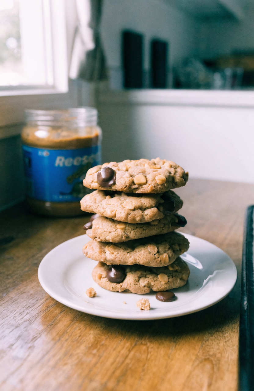 Plate of peanut butter Reese's cookies with visible Reese's Pieces and peanut butter chips